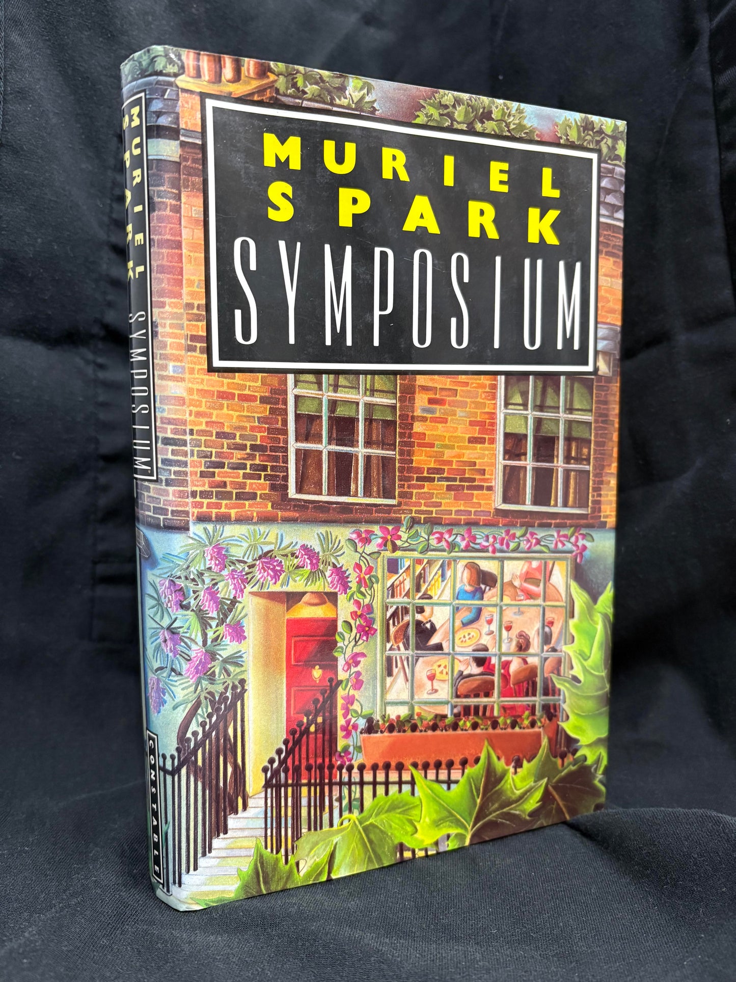 Symposium.         Muriel Spark